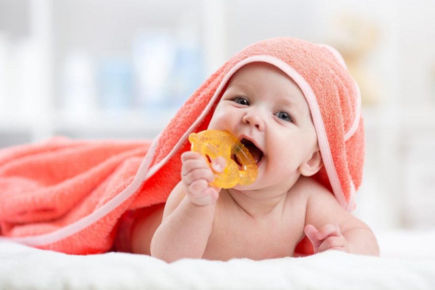 Happy baby with pretzel shaped teething toy 