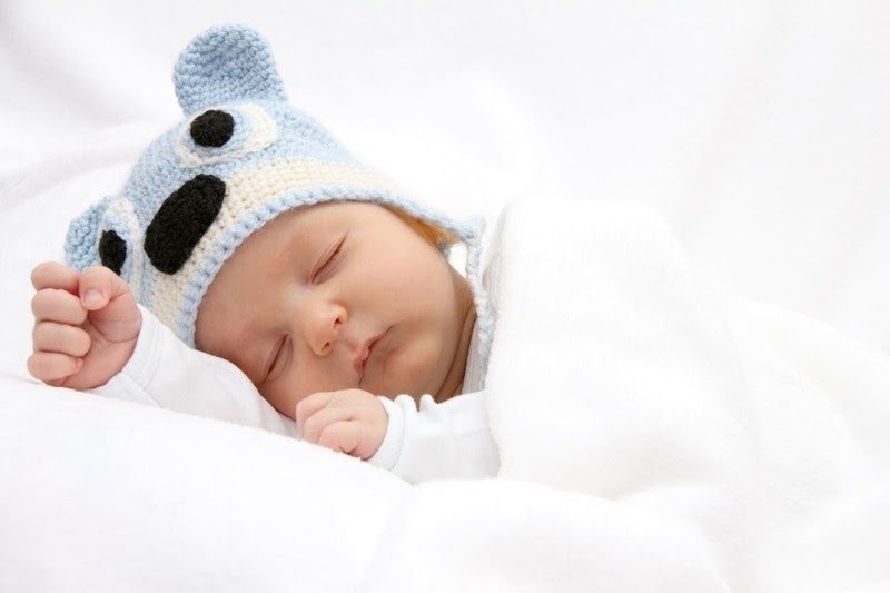 baby girl knee high socks with bows - sleeping baby with a white blanket and blue hat image