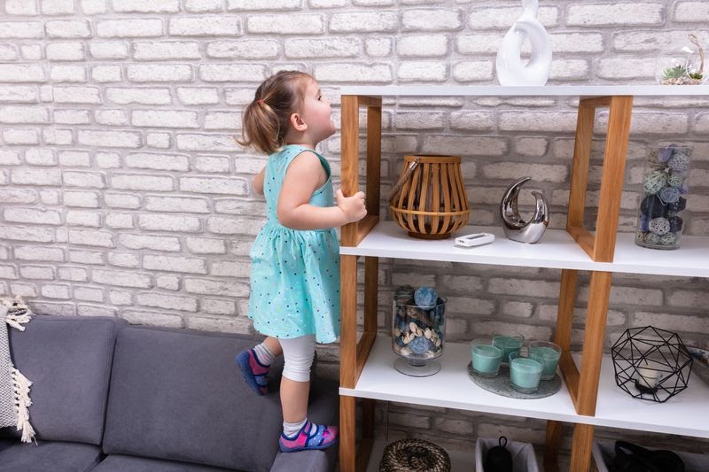 anti tip furniture straps - anti-tip furniture anchor straps - baby girl reaching out on a shelf