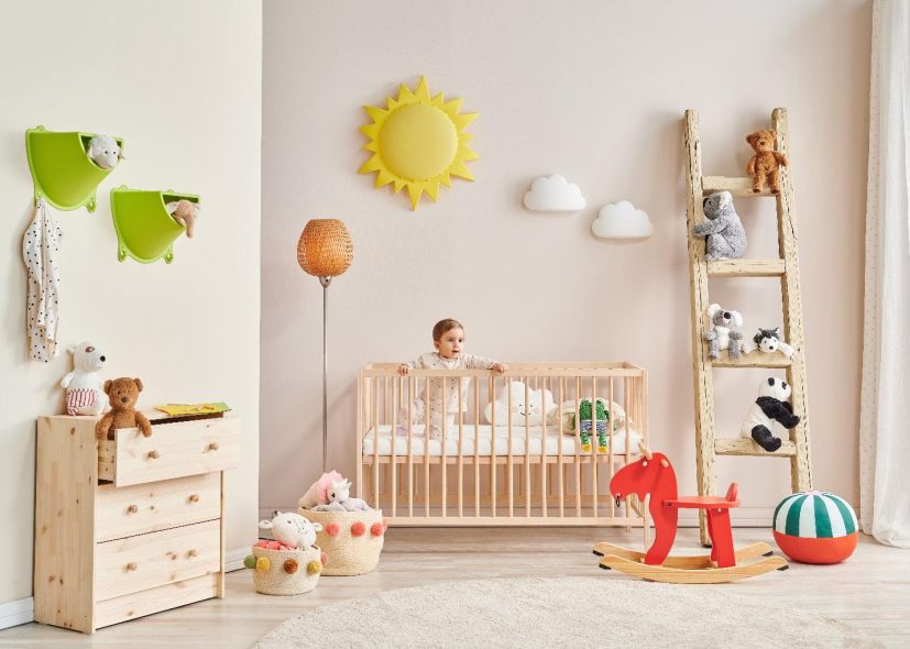 baby inside the crib on a decorated nursery room 